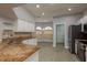 Well-lit kitchen with stainless steel appliances, granite countertops, and a view of the breakfast nook at 22755 Cypress Trail Dr, Lutz, FL 33549