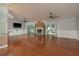 Spacious living room with hardwood floors, a stone fireplace, and sliding glass doors leading to the outdoor area at 22755 Cypress Trail Dr, Lutz, FL 33549