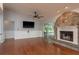 Bright living room with a stone fireplace, hardwood floors, and sliding glass doors to the outdoor area at 22755 Cypress Trail Dr, Lutz, FL 33549