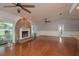 Light-filled living room featuring hardwood floors, stone fireplace, and sliding doors to the outdoor patio at 22755 Cypress Trail Dr, Lutz, FL 33549