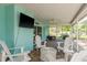 Relaxing outdoor patio with comfortable seating, a ceiling fan, and scenic views of the pool at 22755 Cypress Trail Dr, Lutz, FL 33549