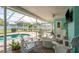 Screened-in lanai with a pool, surrounded by white Adirondack chairs, is the perfect spot for relaxation at 22755 Cypress Trail Dr, Lutz, FL 33549