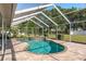 Inviting screened-in pool with a spa and brick paver deck, perfect for relaxation and recreation at 22755 Cypress Trail Dr, Lutz, FL 33549
