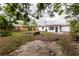 Large backyard with grass and a block firepit at 2324 W Marquette Ave, Tampa, FL 33604