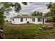 Backyard featuring a modern block home and some foliage at 2324 W Marquette Ave, Tampa, FL 33604