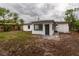 Backyard featuring a modern block home and some foliage at 2324 W Marquette Ave, Tampa, FL 33604
