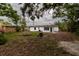 Backyard featuring a modern block home and some foliage at 2324 W Marquette Ave, Tampa, FL 33604