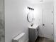 Updated bathroom features modern vanity, fixtures, and new lighting at 2324 W Marquette Ave, Tampa, FL 33604