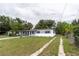 Charming single-story home featuring a carport, freshly painted exterior, and a long driveway at 2324 W Marquette Ave, Tampa, FL 33604