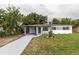 Charming single-story home featuring a carport, freshly painted exterior, and a well-manicured lawn at 2324 W Marquette Ave, Tampa, FL 33604