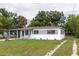 Charming single-story home featuring a carport, freshly painted exterior, and a well-manicured lawn at 2324 W Marquette Ave, Tampa, FL 33604
