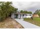 Charming single-story home featuring a carport, freshly painted exterior, and a long driveway at 2324 W Marquette Ave, Tampa, FL 33604