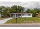 Charming single-story home featuring a carport, freshly painted exterior, and a well-manicured lawn at 2324 W Marquette Ave, Tampa, FL 33604
