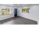 Bright open space with hard surface flooring, a front door, and natural light from large windows at 2324 W Marquette Ave, Tampa, FL 33604