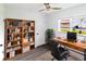 Inviting home office features a wooden desk, bookshelf, and natural light at 2324 W Marquette Ave, Tampa, FL 33604