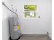 Utility Room with new hot water heater and window at 2324 W Marquette Ave, Tampa, FL 33604