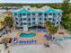 Aerial view of beach condos, featuring a private pool and outdoor lounge area at 24 Gulf Blvd # 1C, Indian Rocks Beach, FL 33785