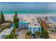 An aerial view of the beachside condo complex with turquoise water and lush surroundings at 24 Gulf Blvd # 1C, Indian Rocks Beach, FL 33785