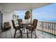 Outdoor balcony with table and chairs overlooking the beach and ocean at 24 Gulf Blvd # 1C, Indian Rocks Beach, FL 33785