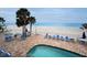 Community pool and brick patio near the beach with lounge chairs at 24 Gulf Blvd # 1C, Indian Rocks Beach, FL 33785