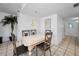 Cozy dining area with tiled flooring, table with four chairs and nautical-themed decorations at 24 Gulf Blvd # 1C, Indian Rocks Beach, FL 33785