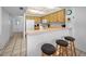 Bright kitchen with countertop seating, natural wood cabinets, and essential appliances at 24 Gulf Blvd # 1C, Indian Rocks Beach, FL 33785