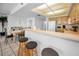 Bright kitchen with breakfast bar seating is open to the dining area at 24 Gulf Blvd # 1C, Indian Rocks Beach, FL 33785