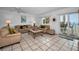 Comfortable living room with sliding glass doors leading to the outdoor patio at 24 Gulf Blvd # 1C, Indian Rocks Beach, FL 33785