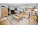 Open-concept living room with tile flooring and a view of the dining area and kitchen at 24 Gulf Blvd # 1C, Indian Rocks Beach, FL 33785
