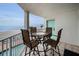Relax on the patio with a table and chairs overlooking the beautiful beach at 24 Gulf Blvd # 1C, Indian Rocks Beach, FL 33785