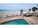 Enjoy the outdoors with a brick patio, inground pool, lounge chairs, and beach views at 24 Gulf Blvd # 1C, Indian Rocks Beach, FL 33785