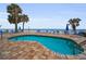 Relaxing pool with beach access, surrounded by palm trees and lounge chairs at 24 Gulf Blvd # 1C, Indian Rocks Beach, FL 33785