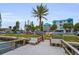Waterfront property featuring a dock and views of well-maintained condominiums at 24 Gulf Blvd # 1C, Indian Rocks Beach, FL 33785