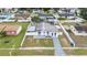 Aerial view of a home with a well-maintained yard, bordered by a white picket fence, in a residential area at 2408 Wishing Well Way, Tampa, FL 33619