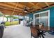 Spacious covered back porch with table and chairs perfect for outdoor gatherings and laundry area at 2408 Wishing Well Way, Tampa, FL 33619