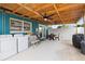 Covered back porch features a ceiling fan, washer, dryer and access to the backyard through a fenced gate at 2408 Wishing Well Way, Tampa, FL 33619