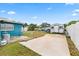 The backyard features a concrete slab, green grass, storage shed, and partial fence at 2408 Wishing Well Way, Tampa, FL 33619
