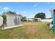 Large backyard showcasing a mesh storage structure and a partial view of the sheds at the property at 2408 Wishing Well Way, Tampa, FL 33619