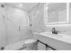 Modern bathroom features a glass-enclosed shower with marble-style walls and contemporary fixtures at 2408 Wishing Well Way, Tampa, FL 33619