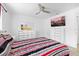Bright bedroom featuring stylish furniture, TV, ceiling fan and a window offering natural light at 2408 Wishing Well Way, Tampa, FL 33619