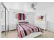 Bright bedroom featuring stylish furniture, ceiling fan and a window offering natural light at 2408 Wishing Well Way, Tampa, FL 33619