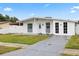 Inviting home with a lush green lawn and a well-maintained, classic facade at 2408 Wishing Well Way, Tampa, FL 33619