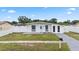 Single-story home featuring a well-manicured lawn and a classic, welcoming entrance at 2408 Wishing Well Way, Tampa, FL 33619