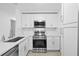Modern kitchen featuring stainless steel appliances, white cabinets and countertops at 2408 Wishing Well Way, Tampa, FL 33619