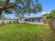 Exterior shot of the backyard featuring a large tree that provides some shade at 2432 Keene Park Dr, Largo, FL 33771