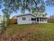 Exterior shot of the backyard featuring a large tree that provides some shade at 2432 Keene Park Dr, Largo, FL 33771