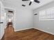 Empty room with beautiful wood laminate flooring, a ceiling fan, and white-stained shutters at 2432 Keene Park Dr, Largo, FL 33771