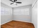 Empty room with beautiful wood laminate flooring, a ceiling fan, and stained shutters at 2432 Keene Park Dr, Largo, FL 33771