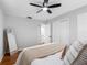 Neutral bedroom featuring a ceiling fan, closet, and a full-length mirror at 2432 Keene Park Dr, Largo, FL 33771