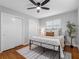 Cozy bedroom features a comfortable bed, a ceiling fan, and a view to the outside at 2432 Keene Park Dr, Largo, FL 33771
